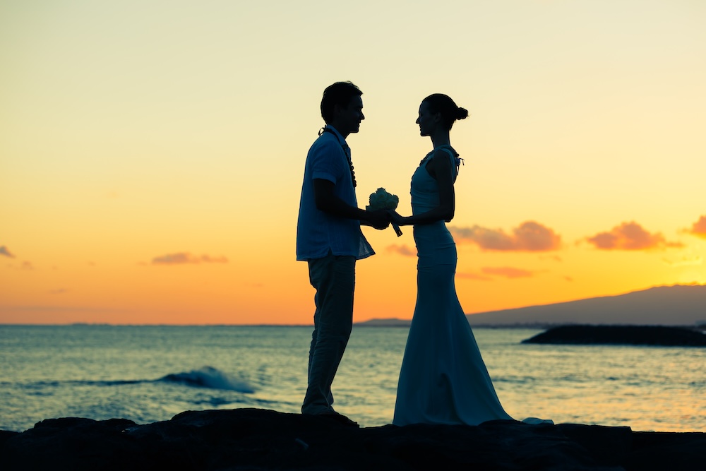 couple getting married in hawaii at the beach at sunset