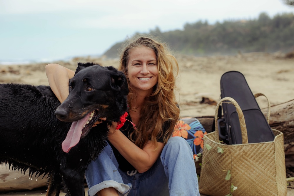 woman on a Kauai beach with a dog