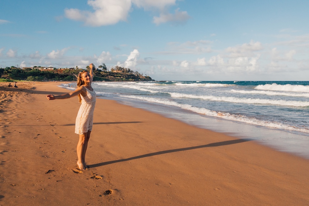 woman on poipu beach kauai