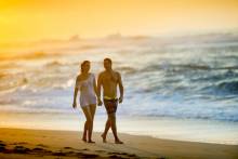 couple on beach at sunset on Kauai