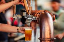 bartender pouring a draft beer from the tap