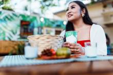 woman sitting at a table looking up like she's talking to someone