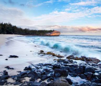 the waves roll into white sands and rocks at shipwrecks beach