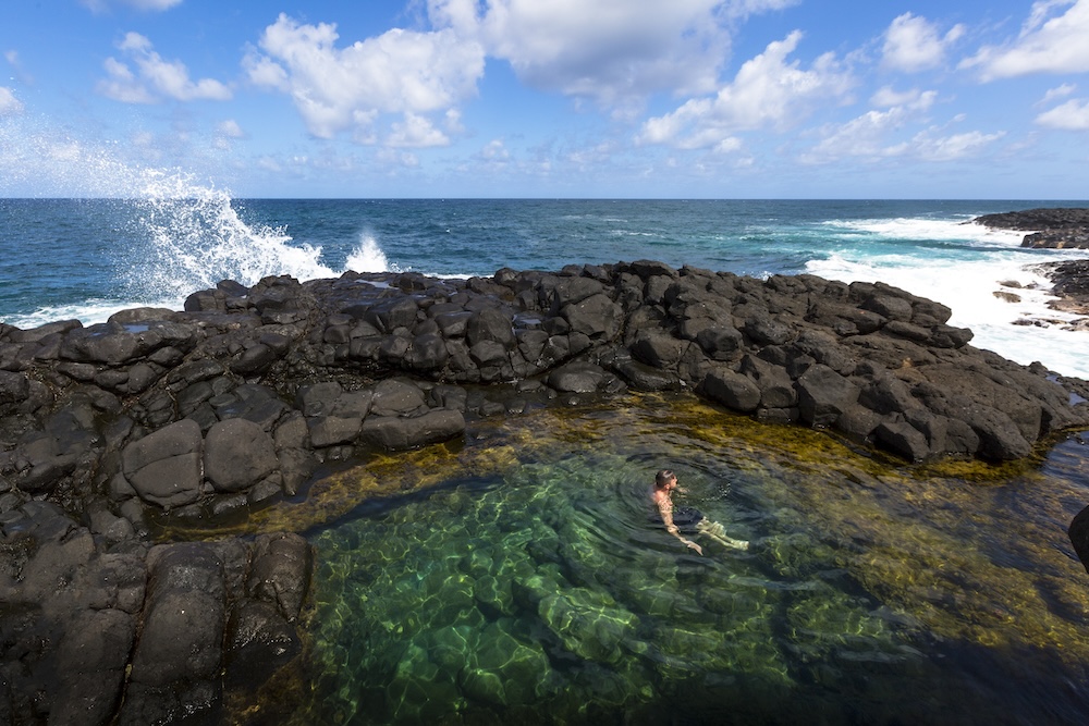 person in tidal pool in Hawaii