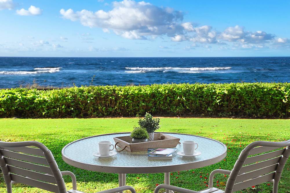 small table set for two looking out at the pacific ocean from a Hawaiian condo vacation rental